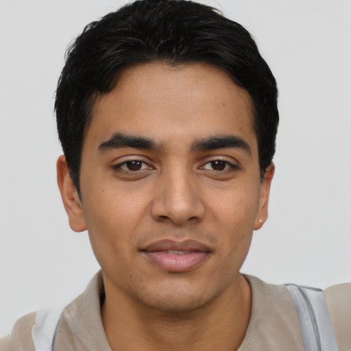 Joyful latino young-adult male with short  black hair and brown eyes