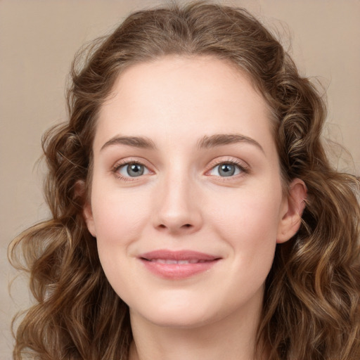 Joyful white young-adult female with long  brown hair and green eyes