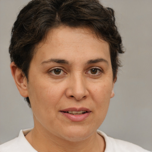 Joyful white adult female with short  brown hair and brown eyes