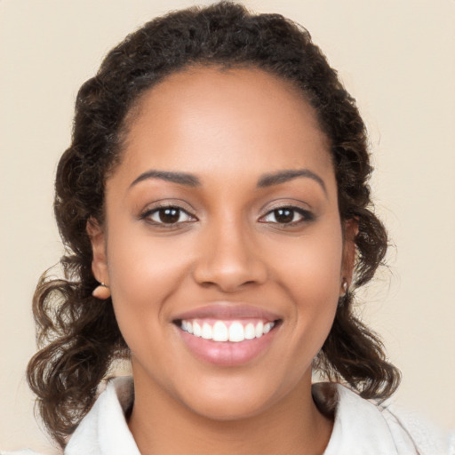 Joyful latino young-adult female with medium  brown hair and brown eyes