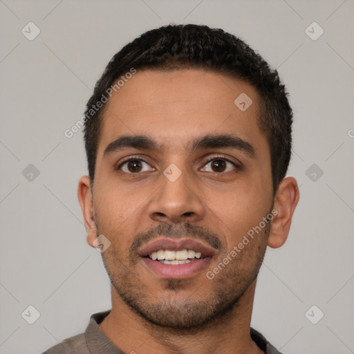 Joyful latino young-adult male with short  black hair and brown eyes