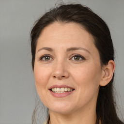 Joyful white adult female with long  brown hair and brown eyes