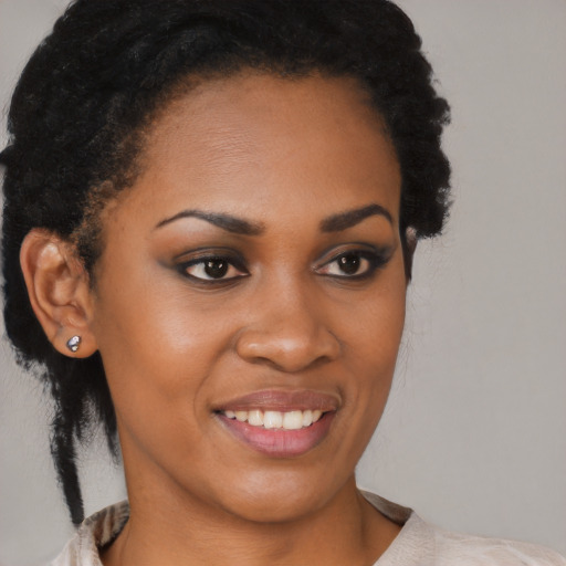 Joyful black young-adult female with short  black hair and brown eyes