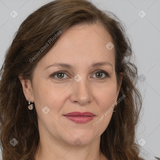 Joyful white adult female with long  brown hair and brown eyes