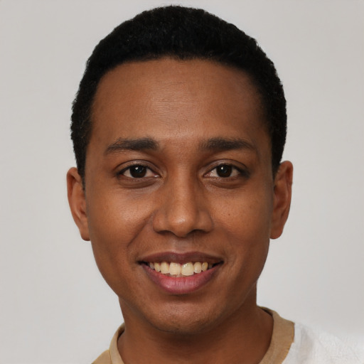 Joyful black young-adult male with short  black hair and brown eyes