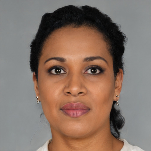 Joyful black young-adult female with short  black hair and brown eyes