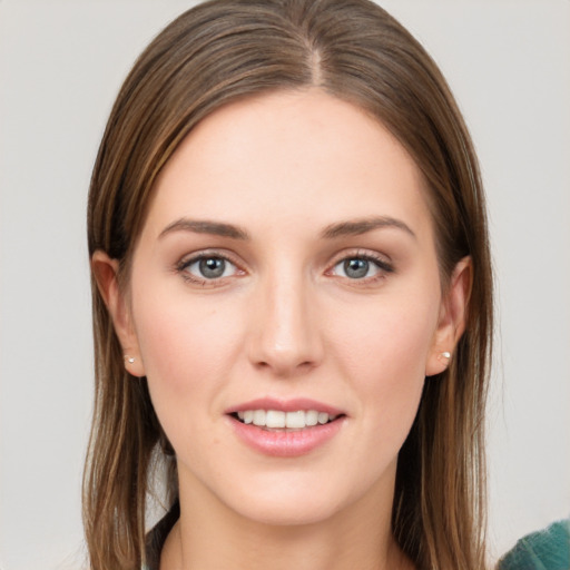 Joyful white young-adult female with long  brown hair and grey eyes