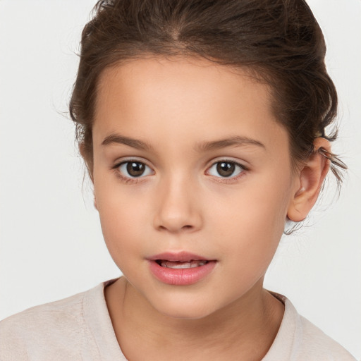 Joyful white child female with short  brown hair and brown eyes