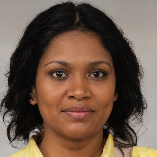 Joyful black young-adult female with medium  brown hair and brown eyes