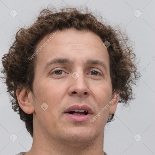 Joyful white adult male with short  brown hair and grey eyes