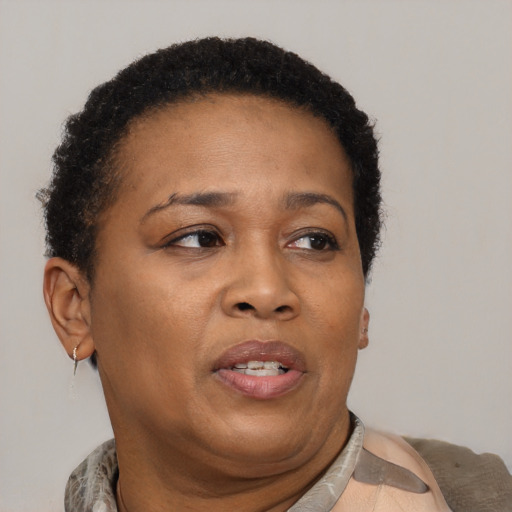 Joyful black adult female with short  brown hair and brown eyes