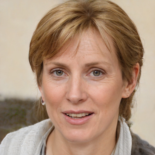 Joyful white adult female with medium  brown hair and blue eyes