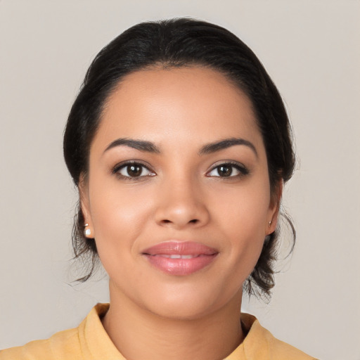 Joyful latino young-adult female with medium  black hair and brown eyes