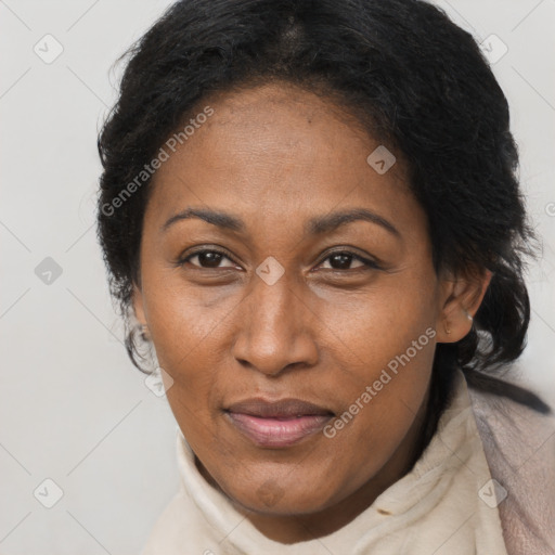 Joyful black adult female with long  brown hair and brown eyes