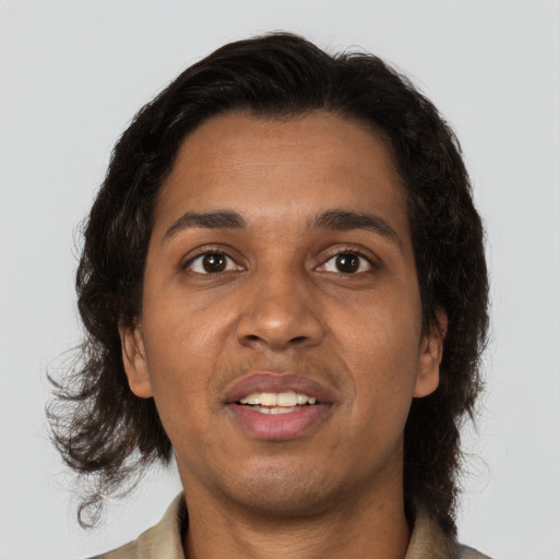 Joyful black adult male with medium  brown hair and brown eyes