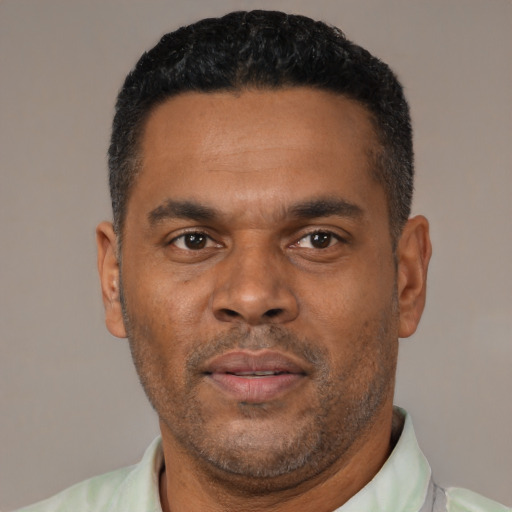 Neutral latino adult male with short  black hair and brown eyes