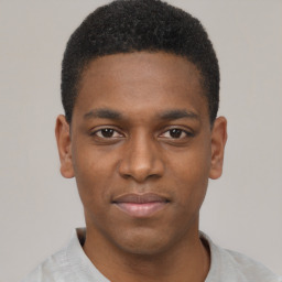 Joyful black young-adult male with short  brown hair and brown eyes