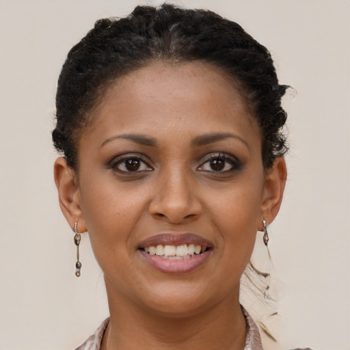 Joyful black young-adult female with short  brown hair and brown eyes