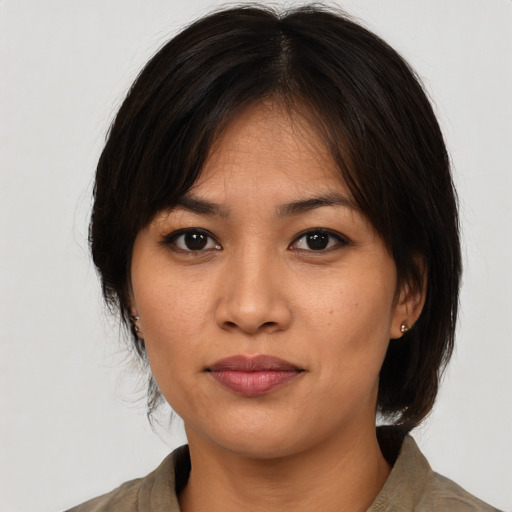 Joyful asian young-adult female with medium  black hair and brown eyes