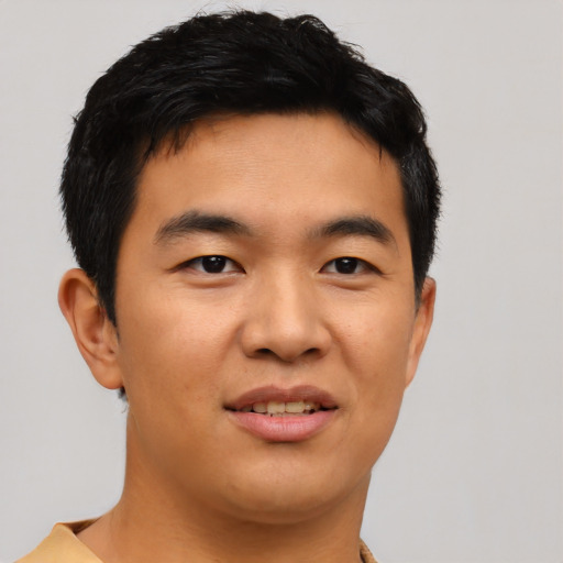 Joyful asian young-adult male with short  black hair and brown eyes