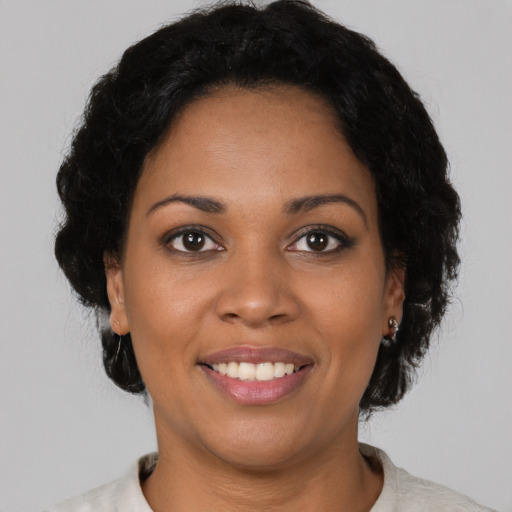 Joyful latino young-adult female with short  brown hair and brown eyes