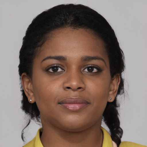 Joyful black young-adult female with medium  black hair and brown eyes