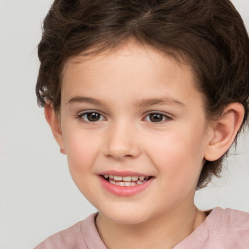 Joyful white child female with short  brown hair and brown eyes