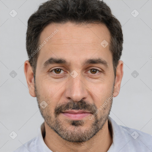 Joyful white adult male with short  black hair and brown eyes