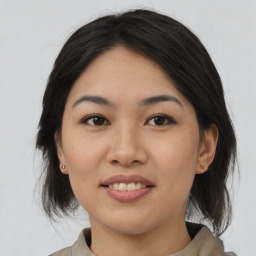 Joyful asian young-adult female with medium  black hair and brown eyes