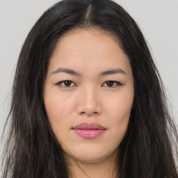 Joyful asian young-adult female with long  brown hair and brown eyes