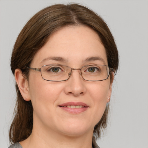 Joyful white adult female with medium  brown hair and grey eyes