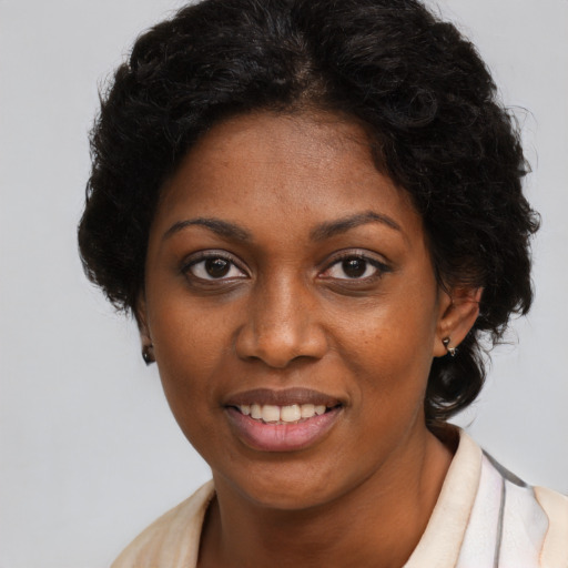 Joyful black young-adult female with short  brown hair and brown eyes