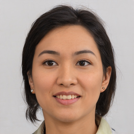 Joyful asian young-adult female with medium  brown hair and brown eyes