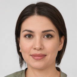 Joyful white young-adult female with medium  brown hair and brown eyes