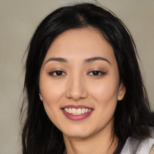 Joyful asian young-adult female with long  black hair and brown eyes