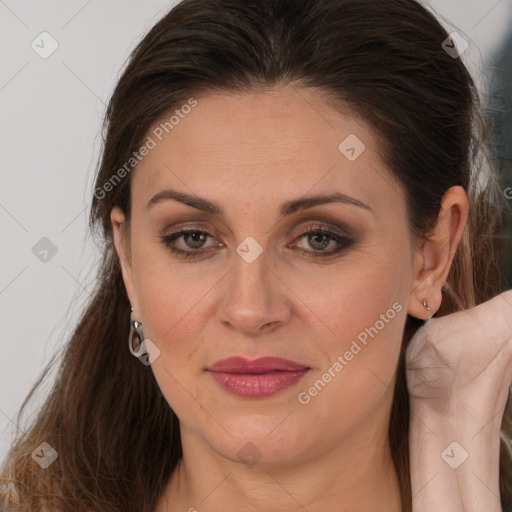 Joyful white adult female with long  brown hair and brown eyes