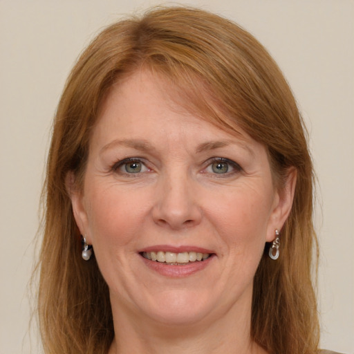 Joyful white adult female with long  brown hair and blue eyes