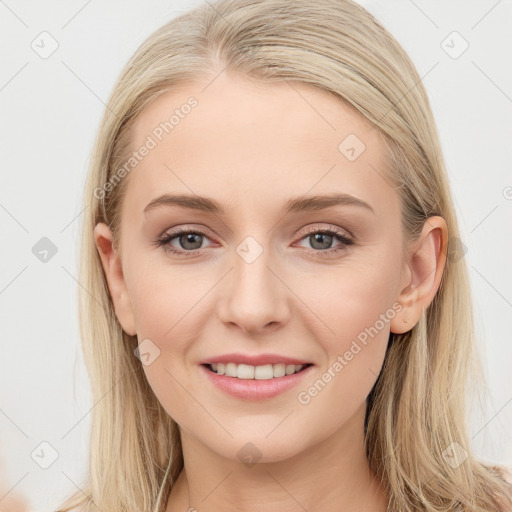 Joyful white young-adult female with long  brown hair and blue eyes