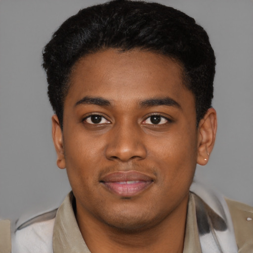 Joyful black young-adult male with short  black hair and brown eyes