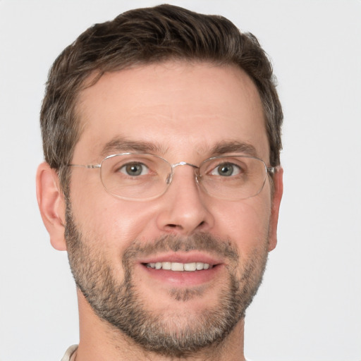 Joyful white adult male with short  brown hair and brown eyes