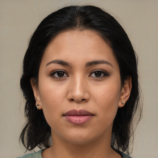 Joyful latino young-adult female with medium  brown hair and brown eyes