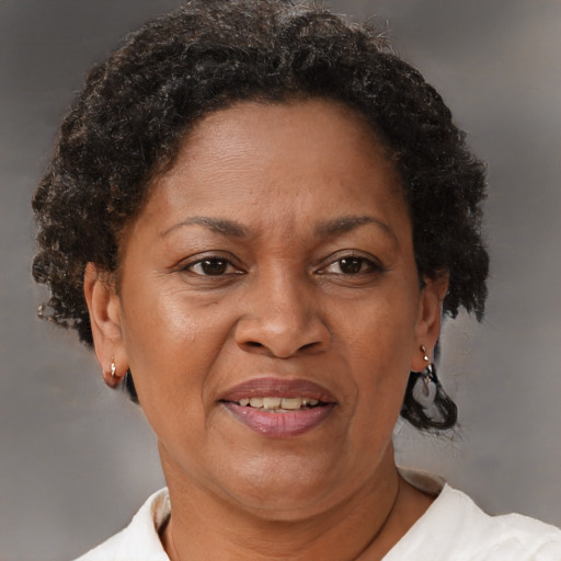 Joyful black adult female with short  brown hair and brown eyes