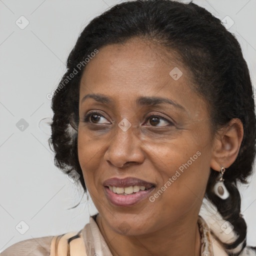 Joyful black adult female with medium  brown hair and brown eyes