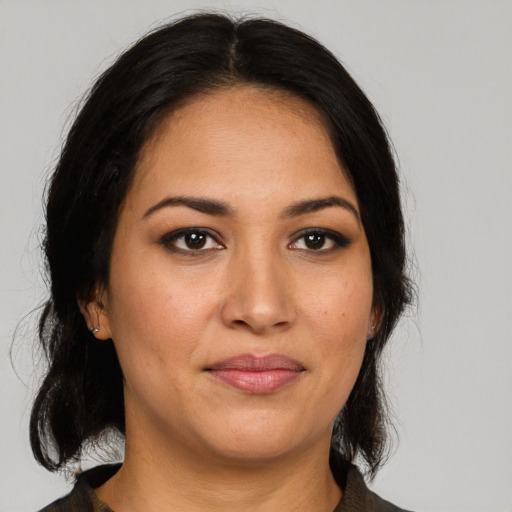 Joyful latino young-adult female with medium  brown hair and brown eyes