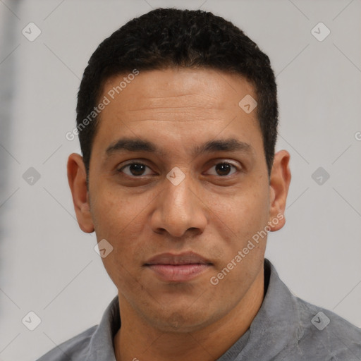 Joyful latino adult male with short  black hair and brown eyes