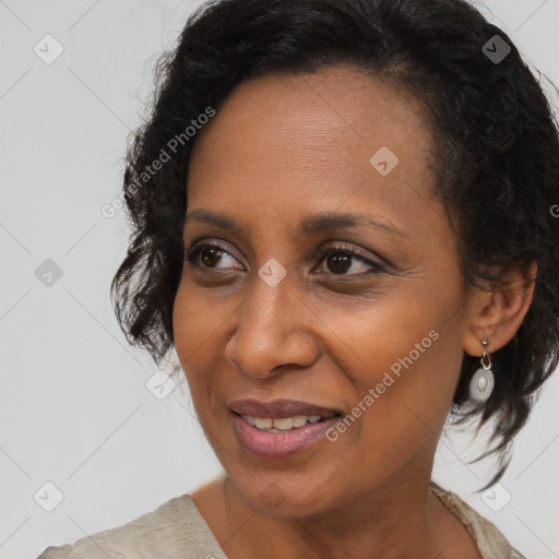 Joyful black adult female with medium  brown hair and brown eyes