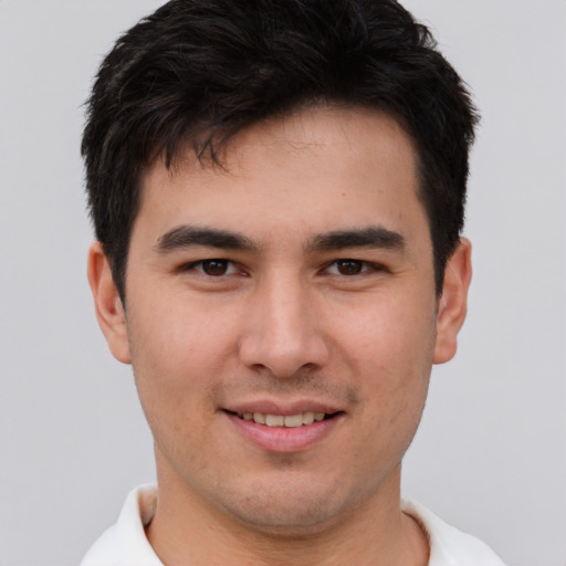 Joyful asian young-adult male with short  brown hair and brown eyes