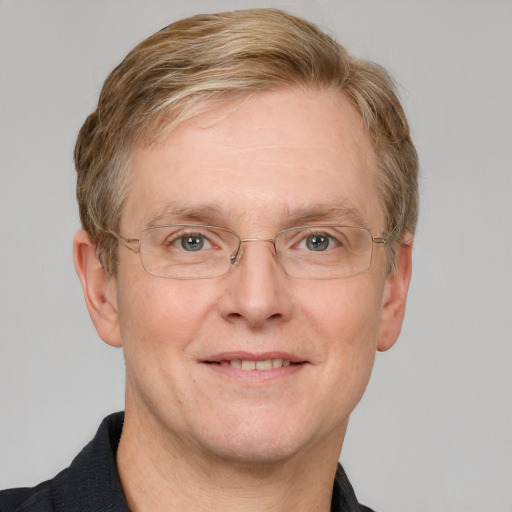 Joyful white adult male with short  brown hair and blue eyes