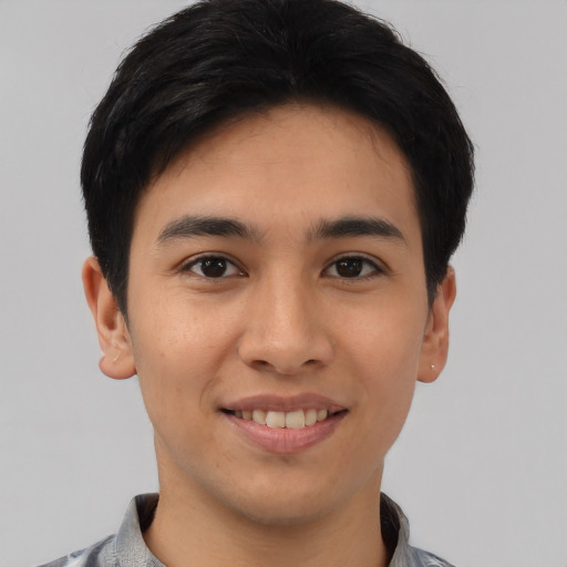Joyful asian young-adult male with short  brown hair and brown eyes
