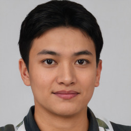 Joyful asian young-adult male with short  black hair and brown eyes